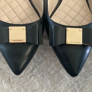Like new Cole Haan black leather flats with bow and gold Cole Haan logo on toe